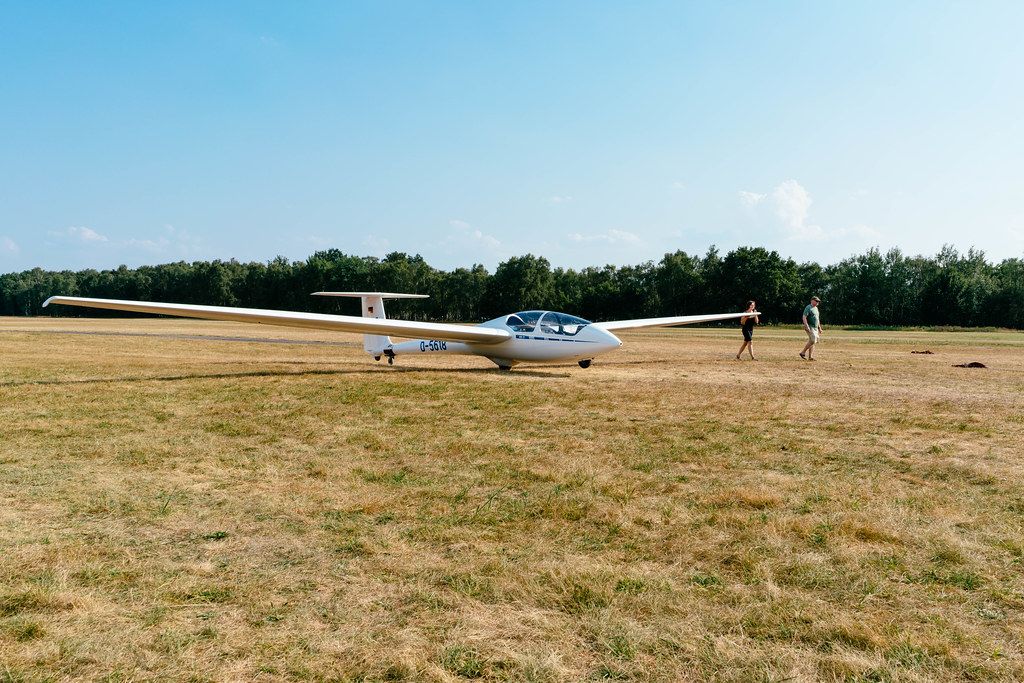 Female student pushing glider by hand to the start position