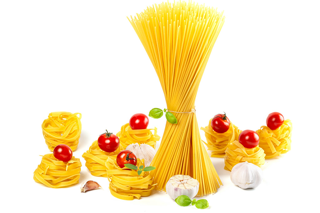 Fettuccine and spaghetti - italian pasta with tomatoes, garlic and basil