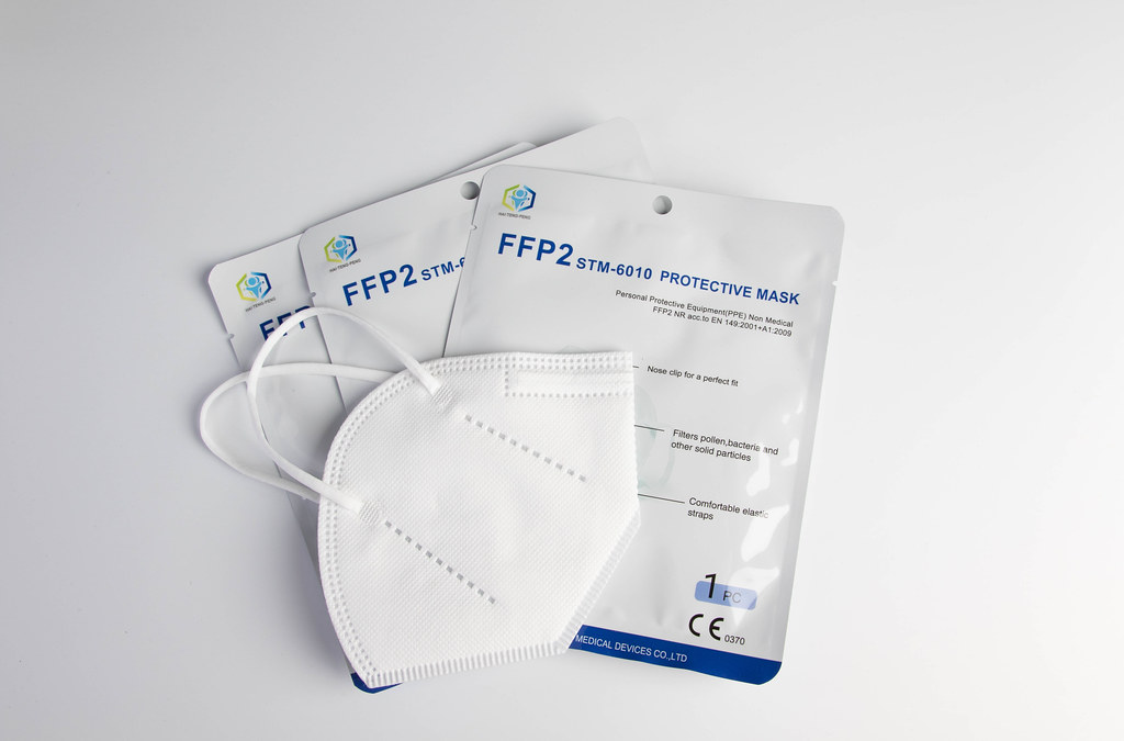 FFP2 medical face mask on white background