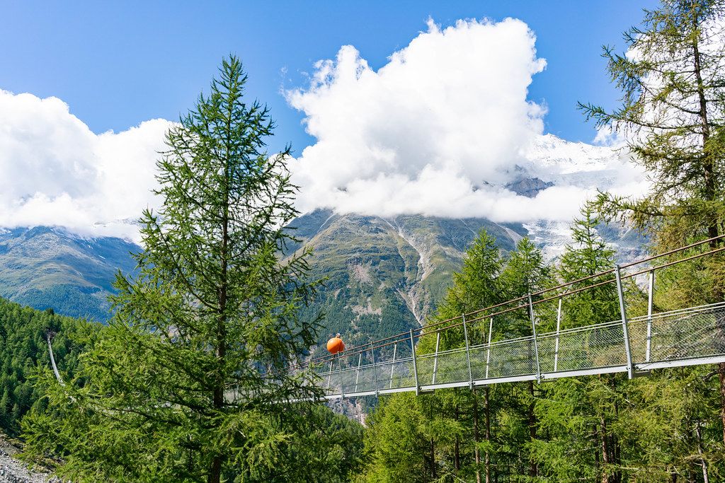 First section of Charles Kuonen suspension bridge with mountain glacier in the background