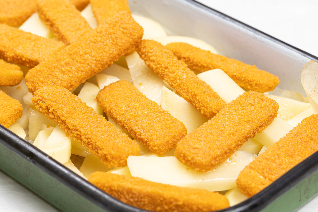 Fish Sticks in the baking tray ready for baking with potatoes