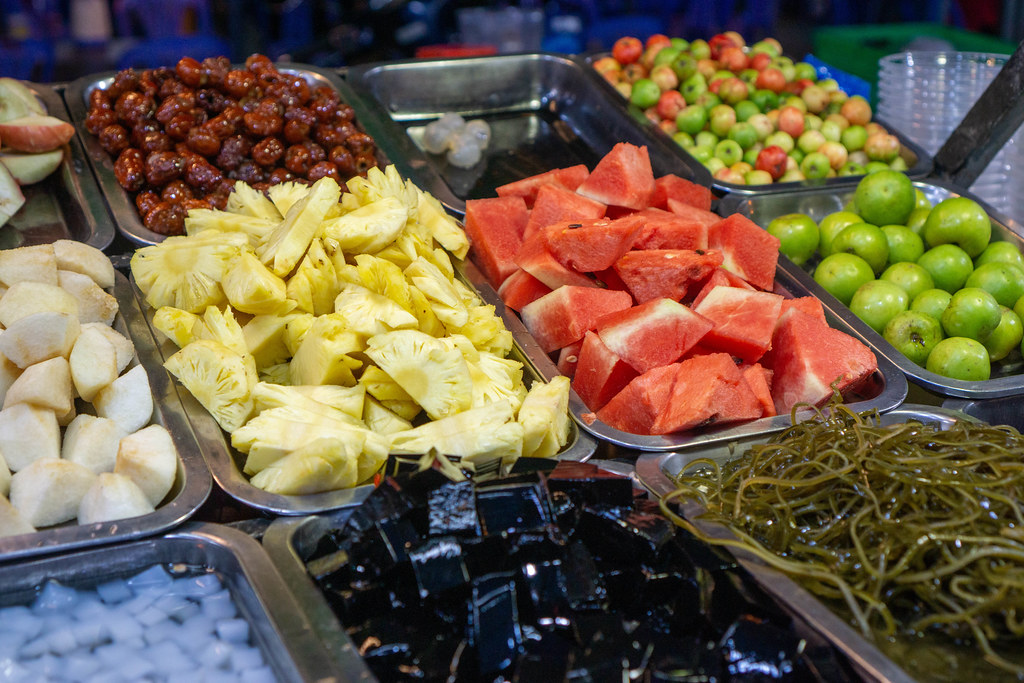 Food Photo of different Fruits such as Pineapple, Watermelon and Apple with Jelly at a Street Food Fruit Bowl Cart at a Night Market in Can Tho, Vietnam
