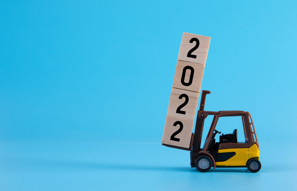 Forklift with 2022 text on wooden blocks