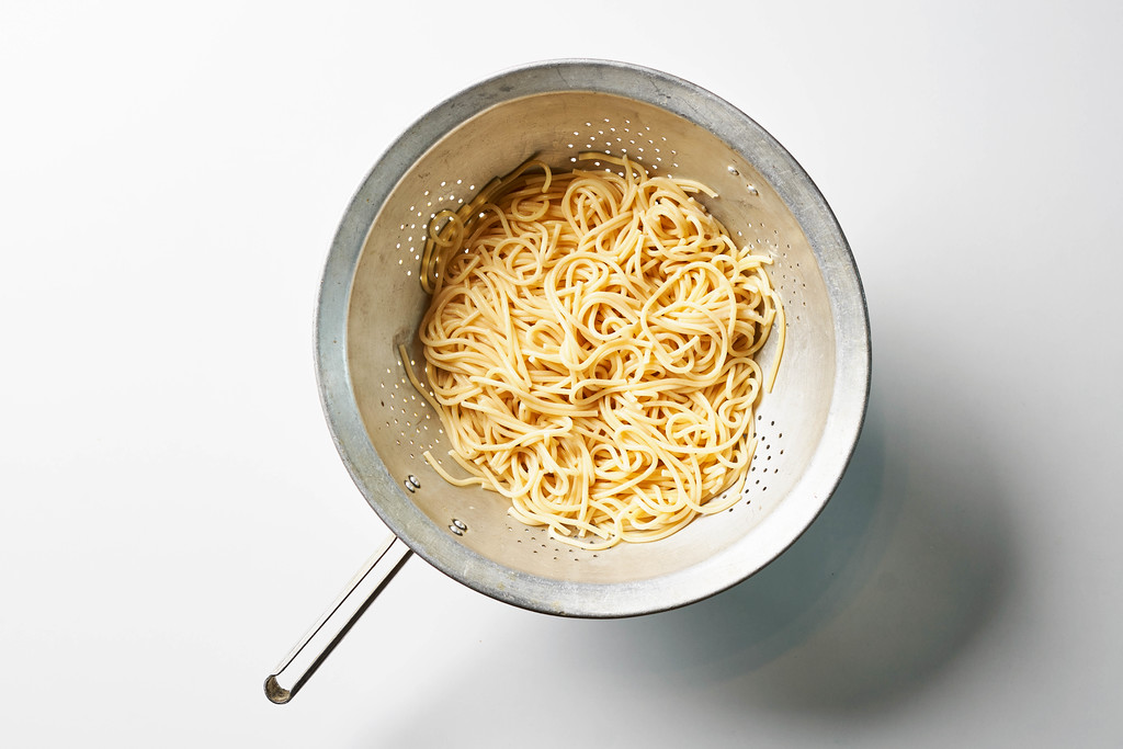 Fresh cooked spaghetti pasta in a colander