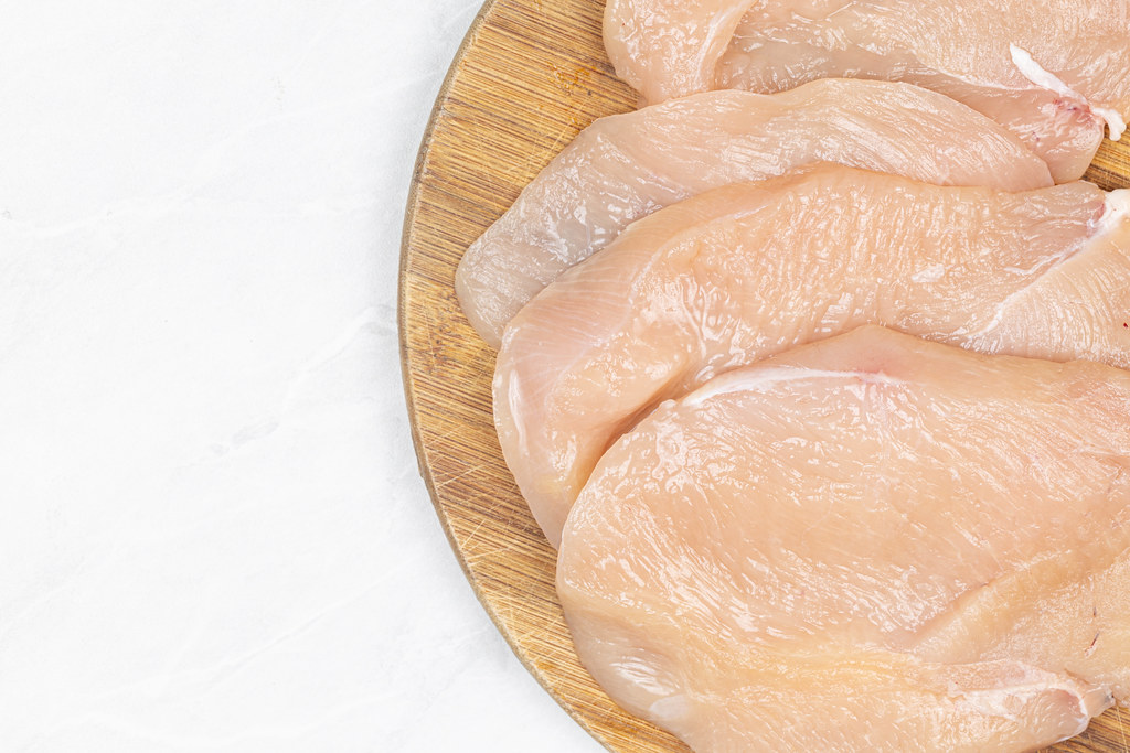 Fresh Raw Chicken meat on the wooden board with copy space