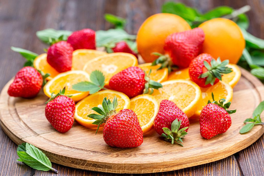 Fresh ripe sliced oranges and strawberries
