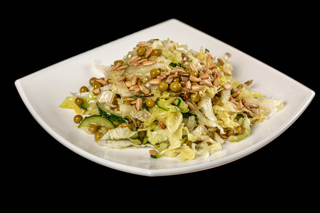 Fresh salad with sunflower seeds, chinese cabbage, peas and cucumbers