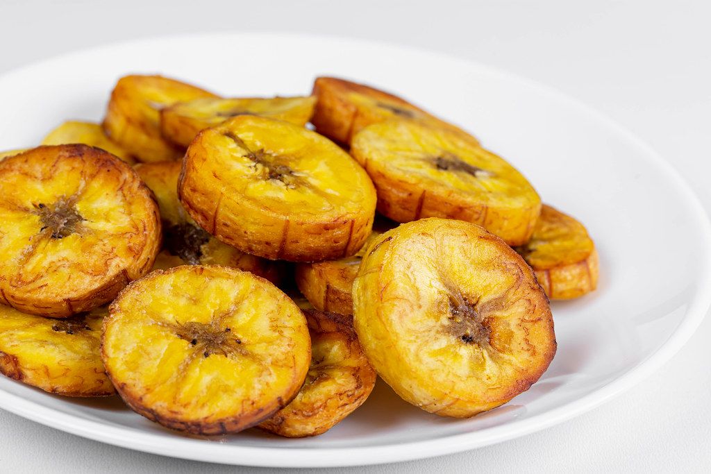 Fried plantain on a white plate, close-up