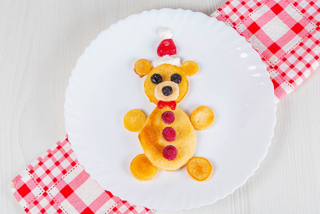 Funny bear pancakes with berries for kids breakfast