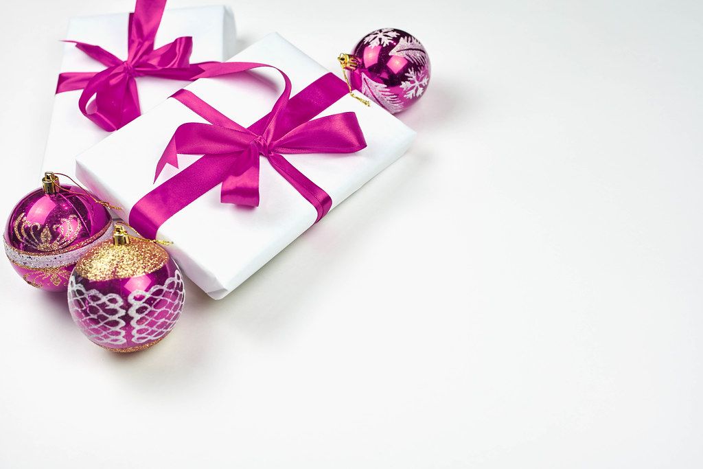 Giftboxes tied with purple-colored ribbons and large copy space