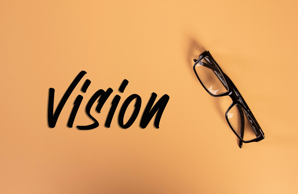Glasses with Vision text on orange background