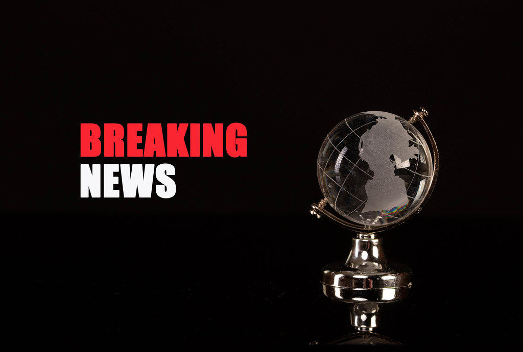 Globe and Breaking News text on black background
