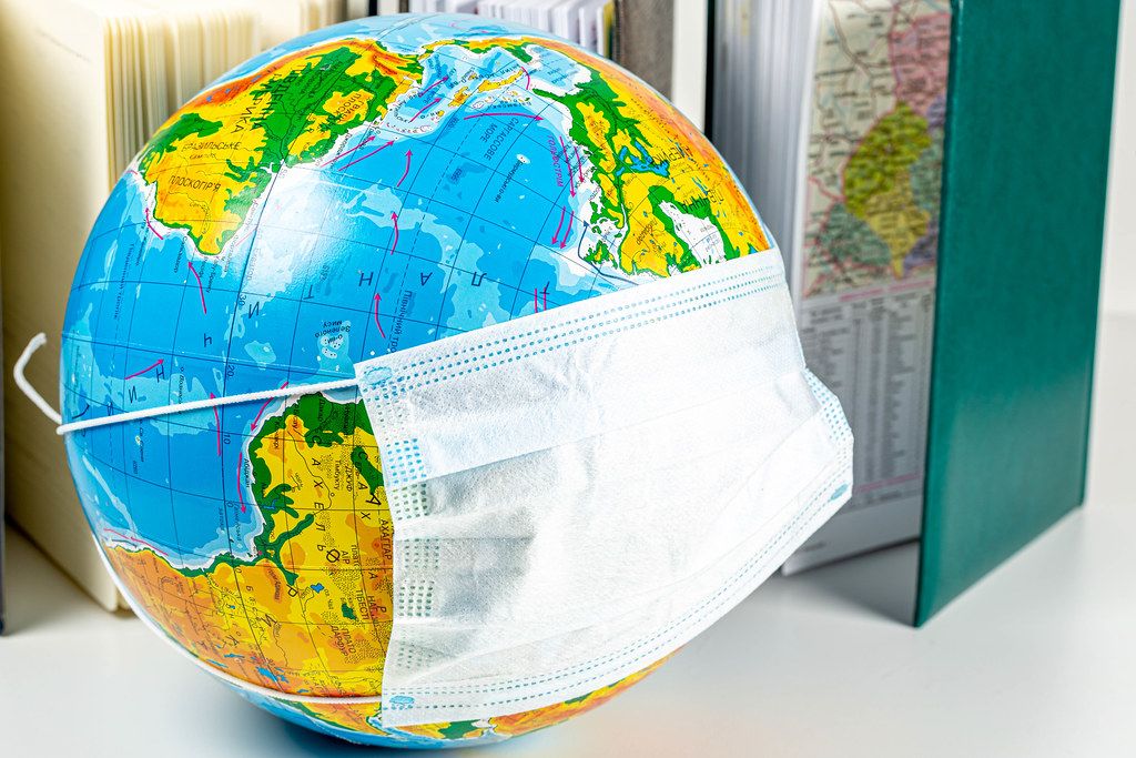 Globe in a medical mask. World danger concept