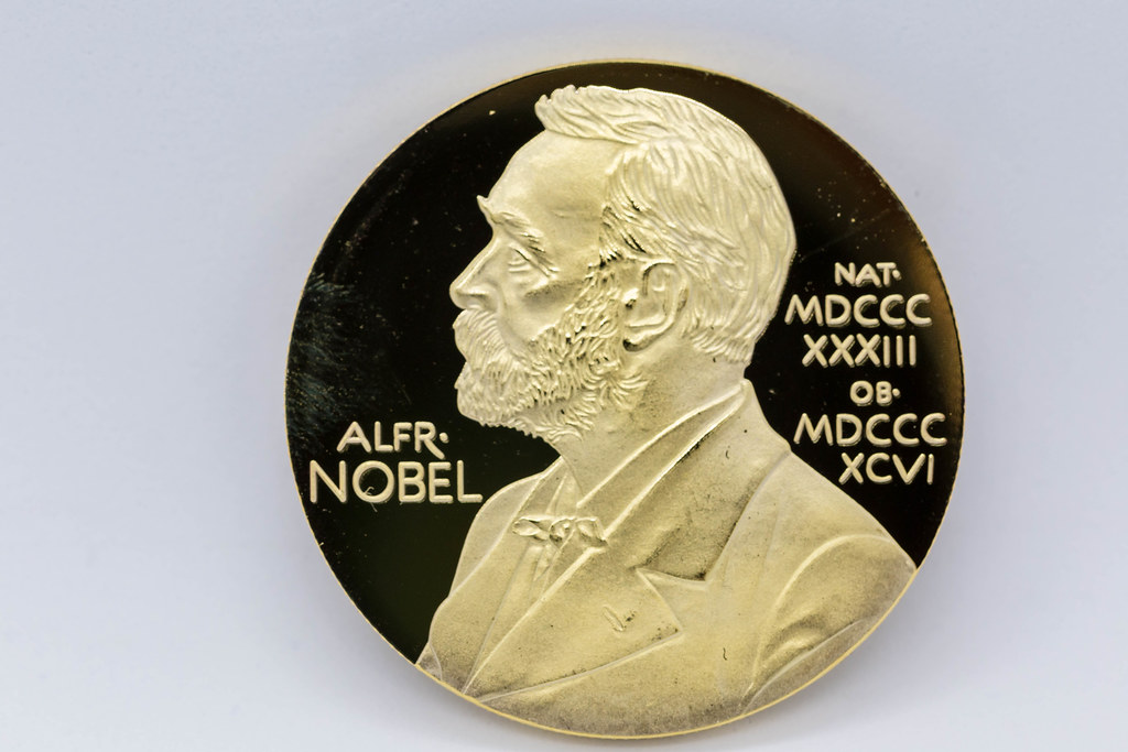 Gold Nobel Prize medal with portrait of Alfred Nobel: macro photo on white background