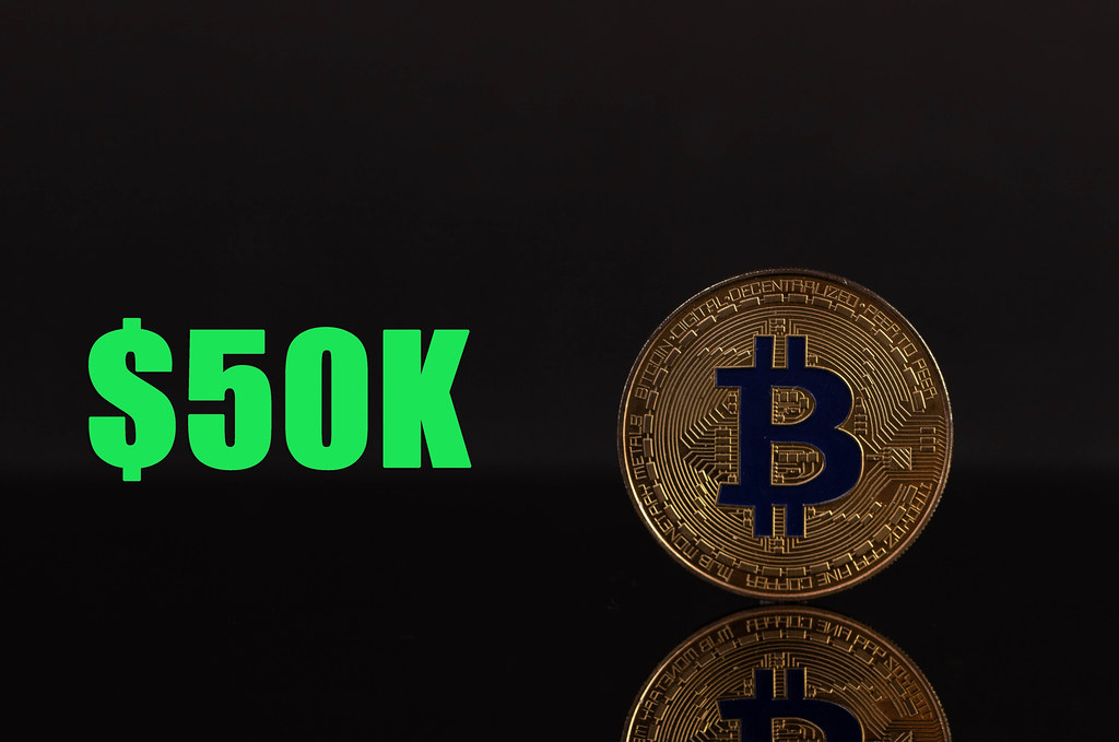Golden Bitcoin with 50k text on black background