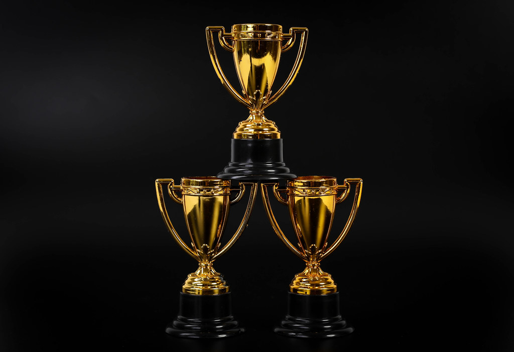 Golden trophies on black background