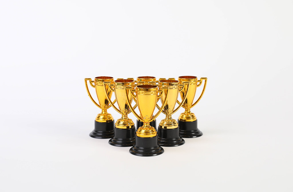 Golden trophies on white background