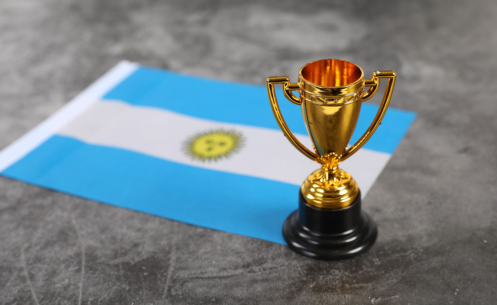 Golden trophy and flag of Argentina
