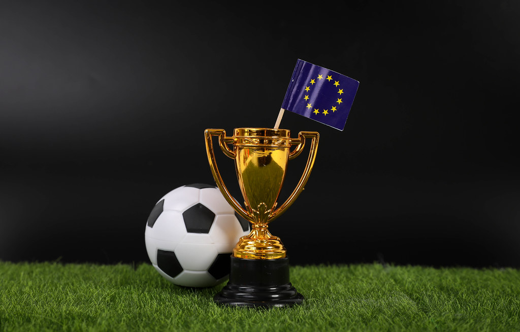 Golden trophy and football ball with flag of European Union