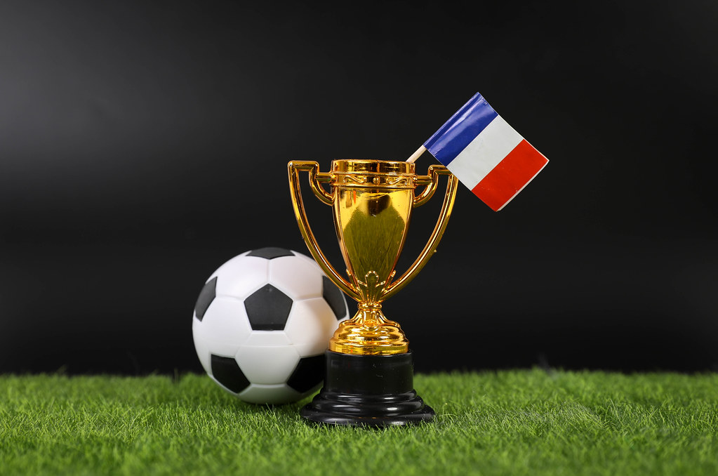 Golden trophy and football ball with flag of France