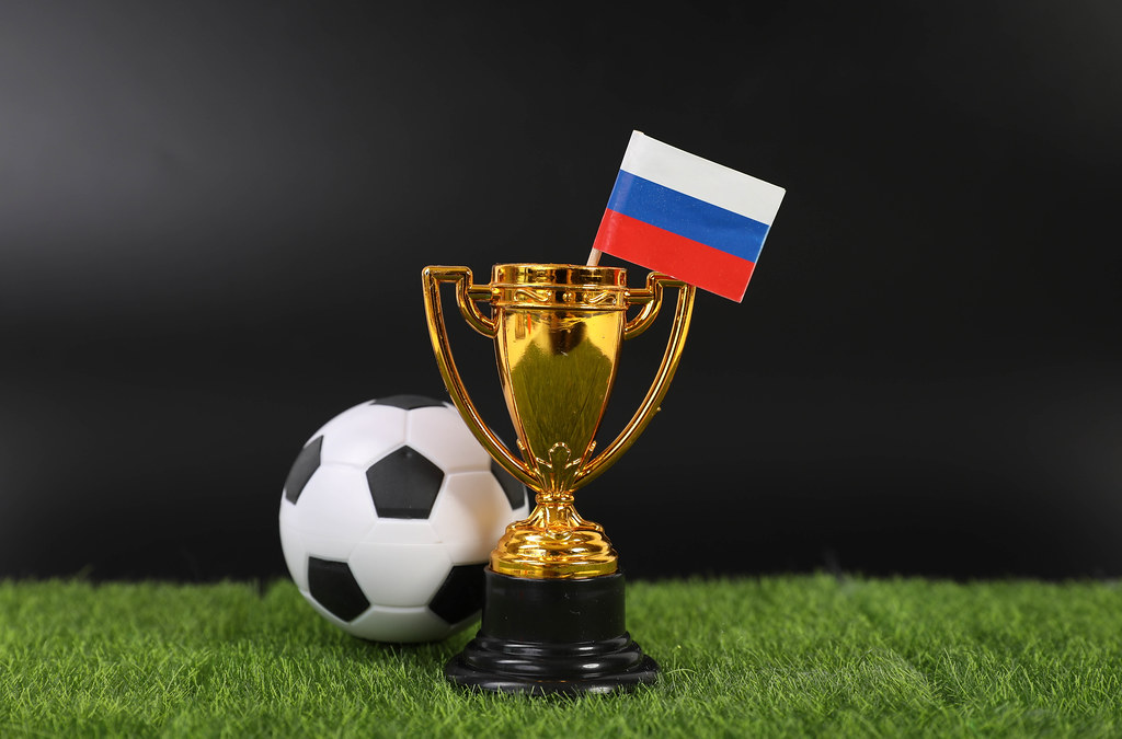 Golden trophy and football ball with flag of Russia