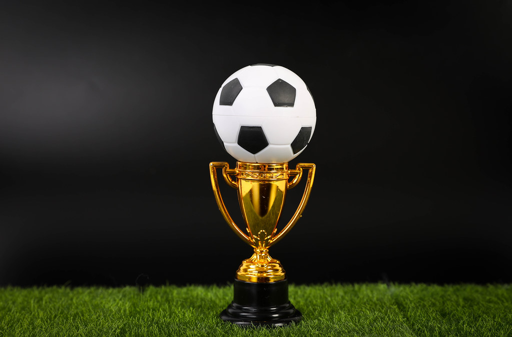 Golden trophy and football ball