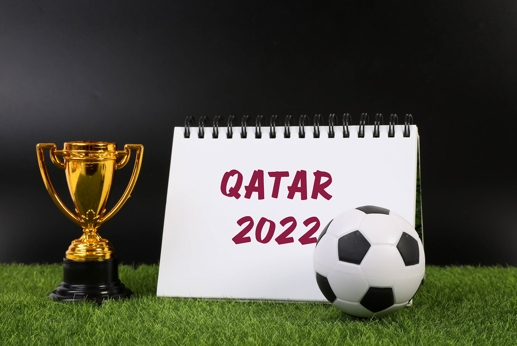 Golden trophy and notebook with Qatar 2022 text