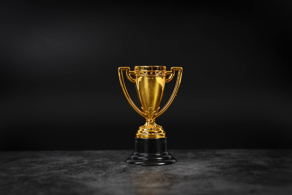 Golden trophy on black background
