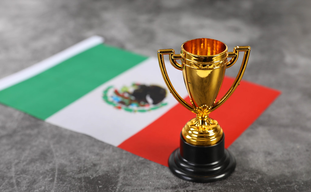 Golden trophy with flag of Mexico
