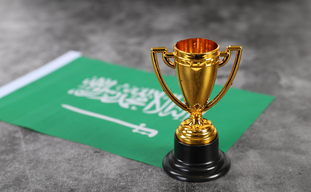 Golden trophy with flag of Saudi Arabia