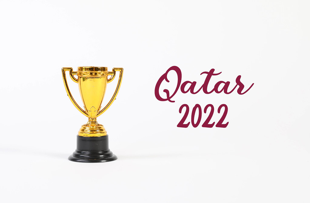 Golden trophy with Qatar 2022 text on white background