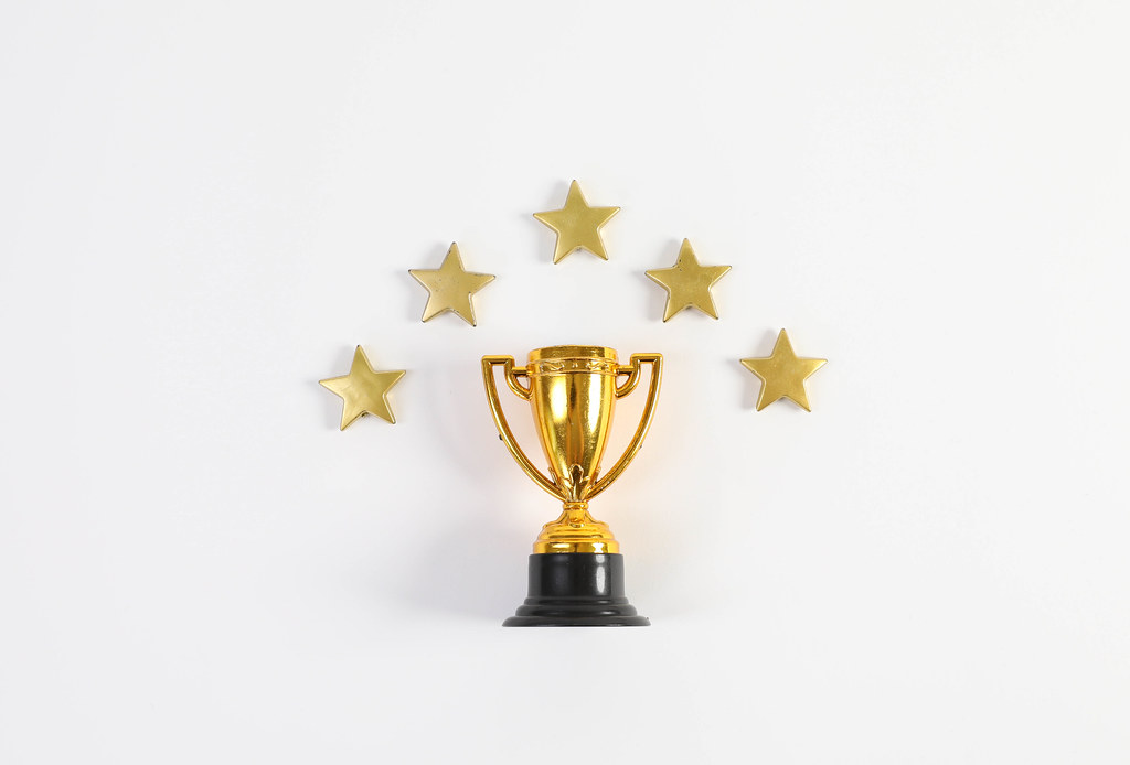 Golden trophy with stars on white background