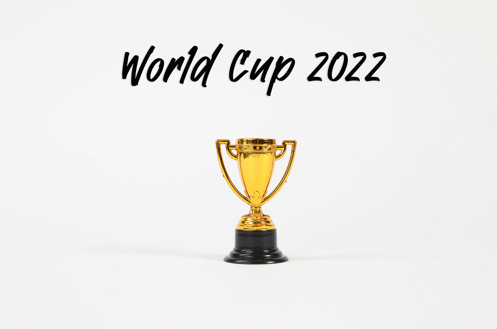 Golden trophy with World Cup 2022 text on white background