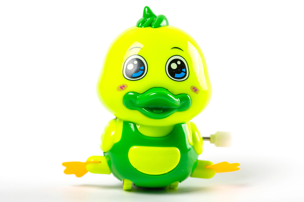 Green duck toy on white background