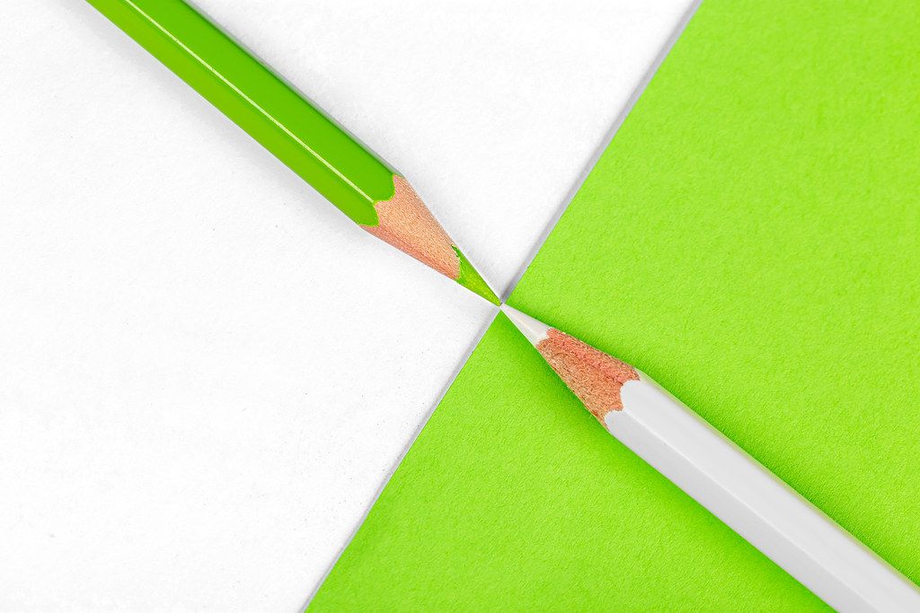 Green pencil on white and white pencil on green background