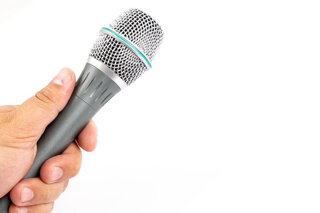 Grey Vocal Microphone with copy space above white background