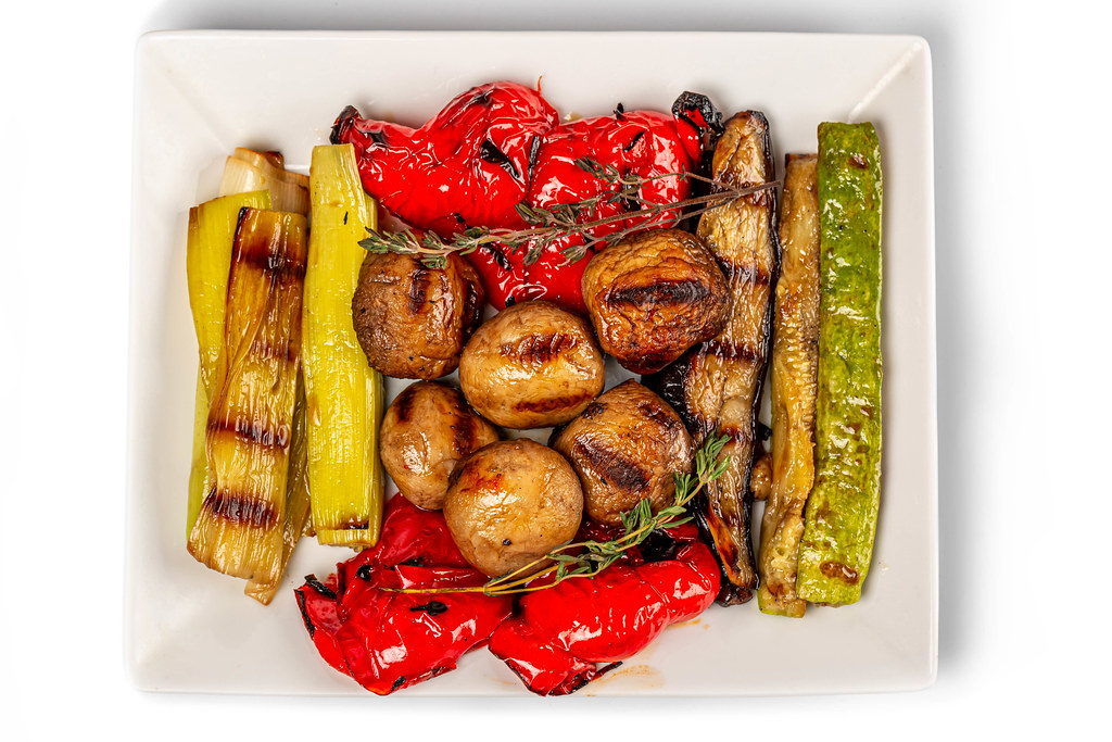 Grilled vegetables mix on plate, top view