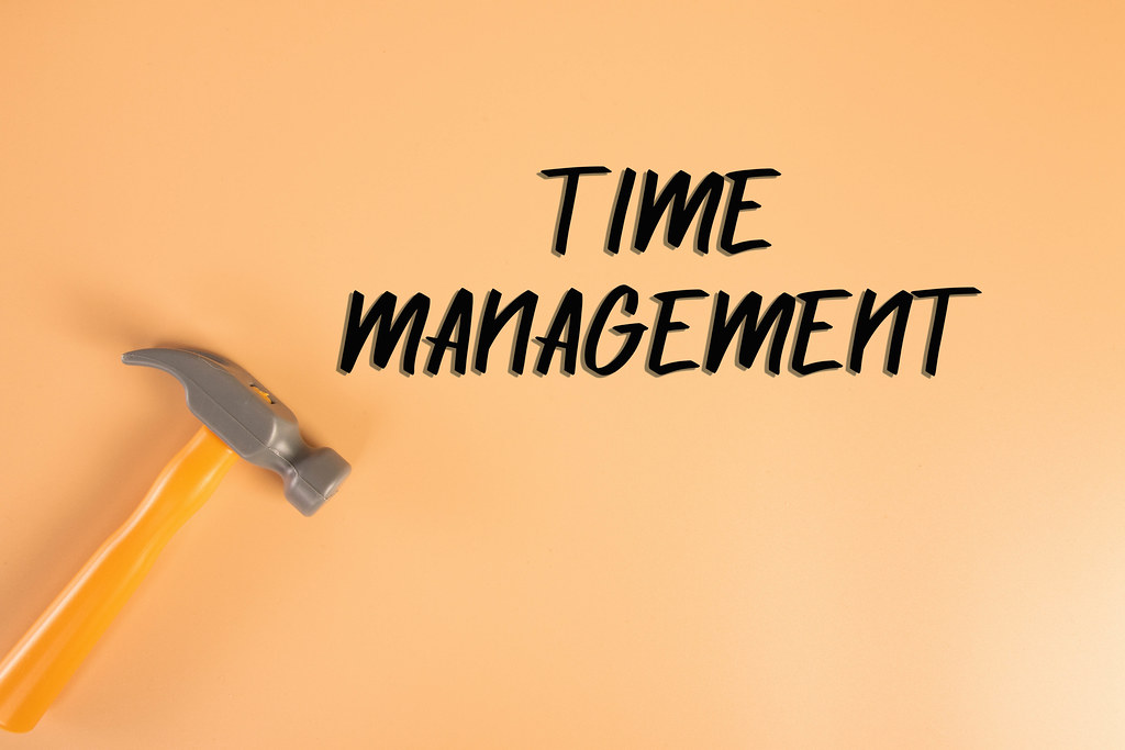 Hammer with Time Management text on orange background