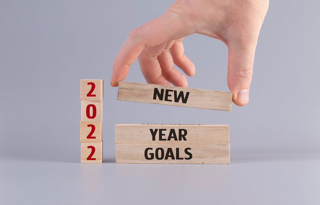 Hand and wooden blocks wih 2022 New Year Goals text
