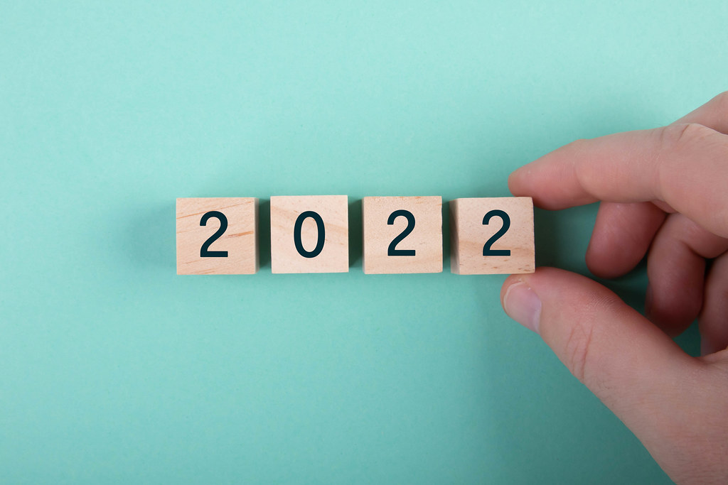 Hand and wooden blocks with 2022 text