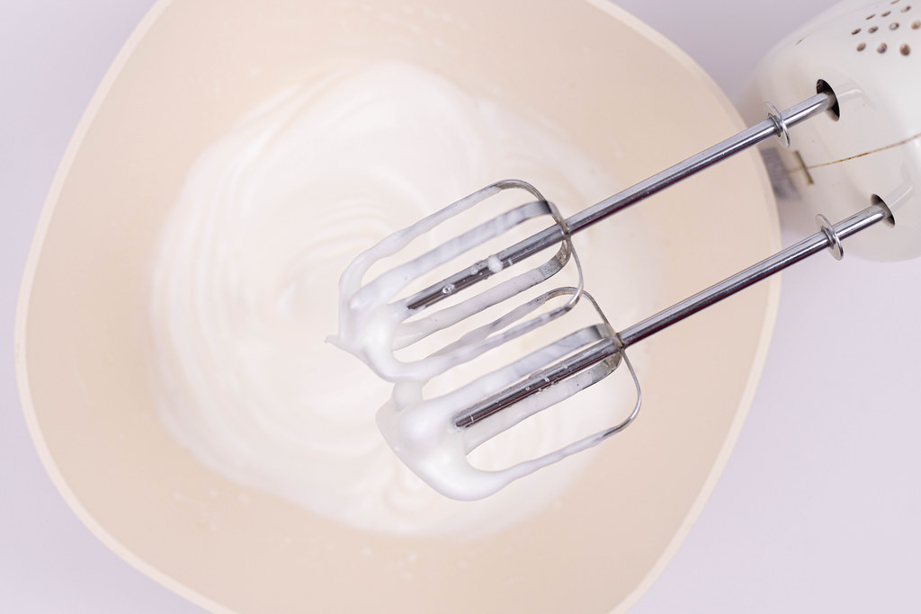 Hand blender above bowl with whipped cream