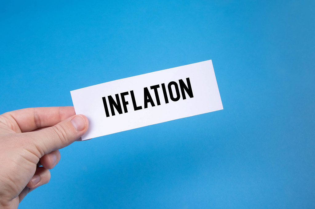 Hand holding a paper with Inflation text