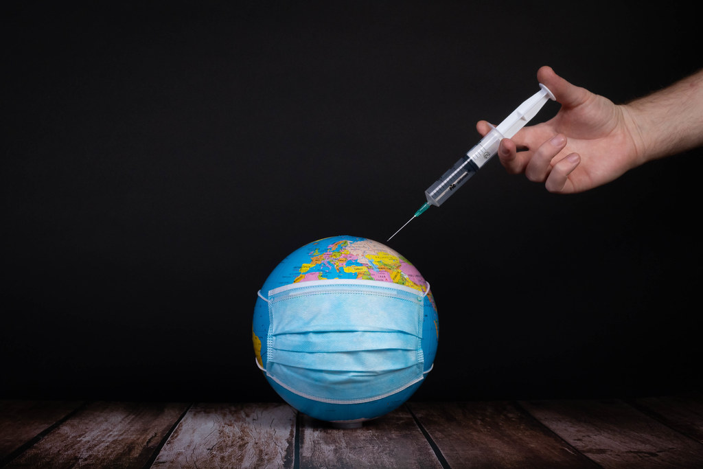 Hand injecitng vaccine into the earth