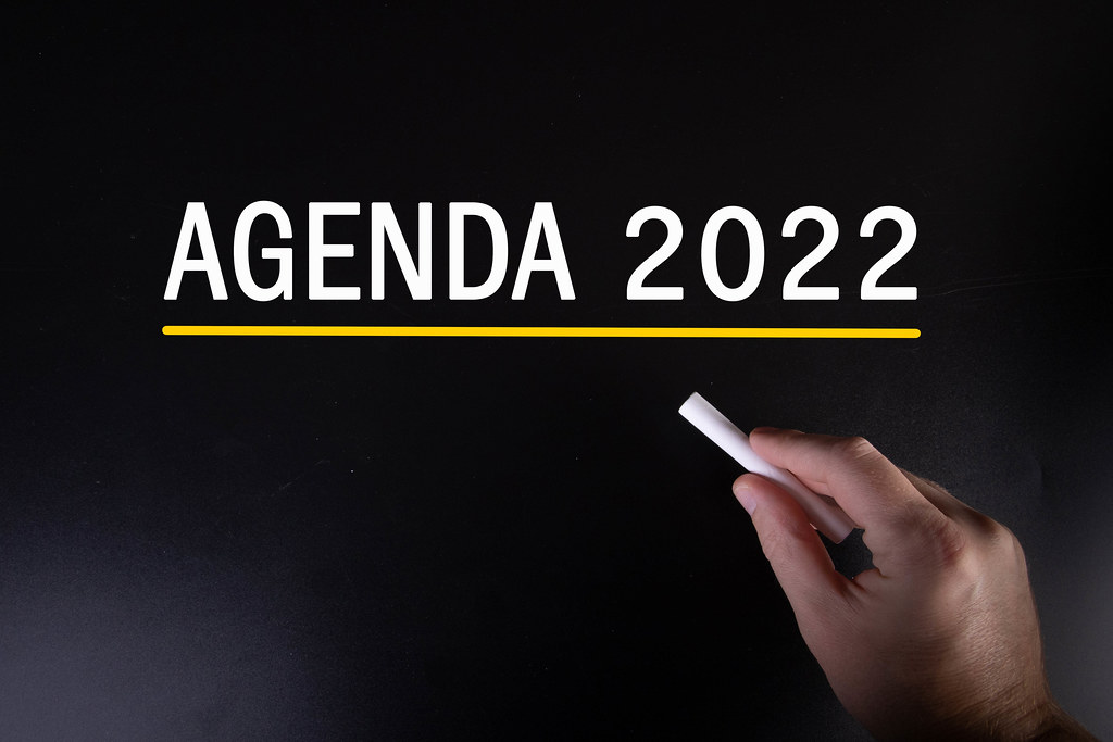 Hand writing Agenda 2022 on blackboard