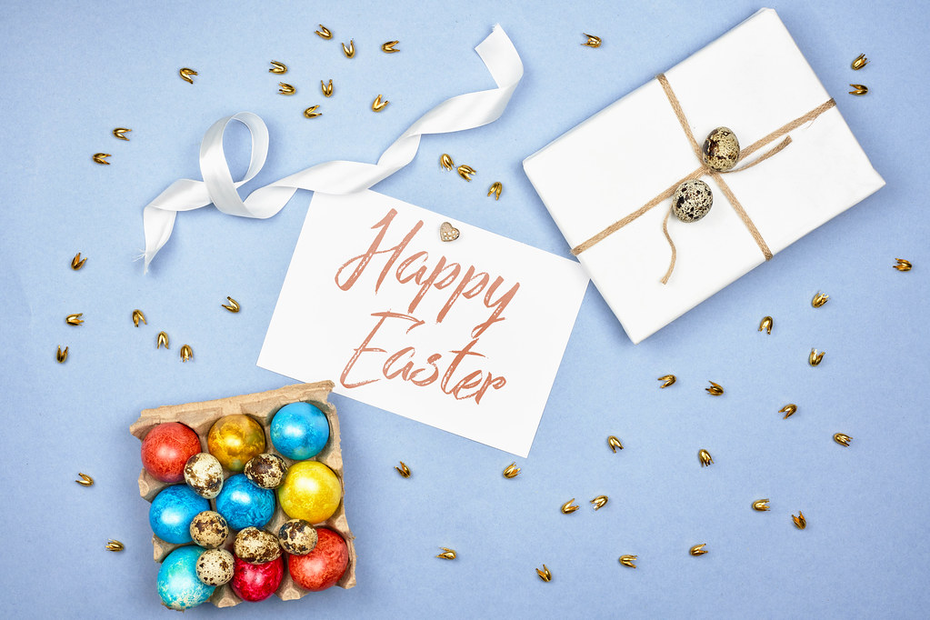 Happy Easter greeting card with gift and decorated festive eggs