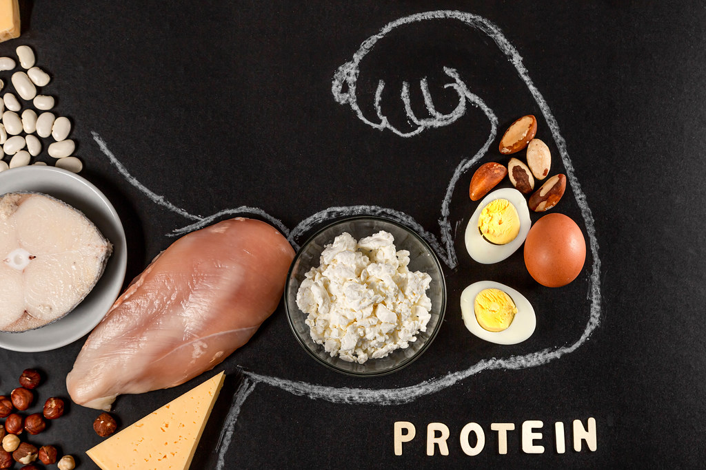 Healthy food and protein products on a dark background lined up in the shape of a hand