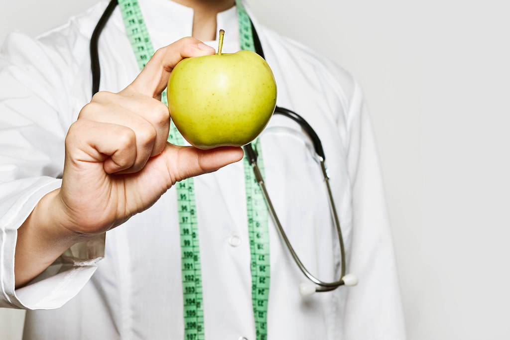 Healthy life, Dieting concept. A doctor hand holds an apple