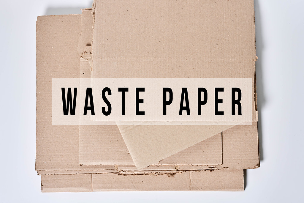 Heap of cardboard for recycling with text - Waste paper