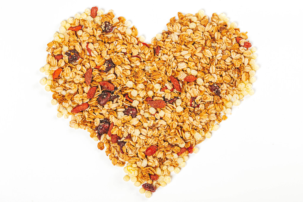 Heart made from dry oatmeal with dried berries and seeds