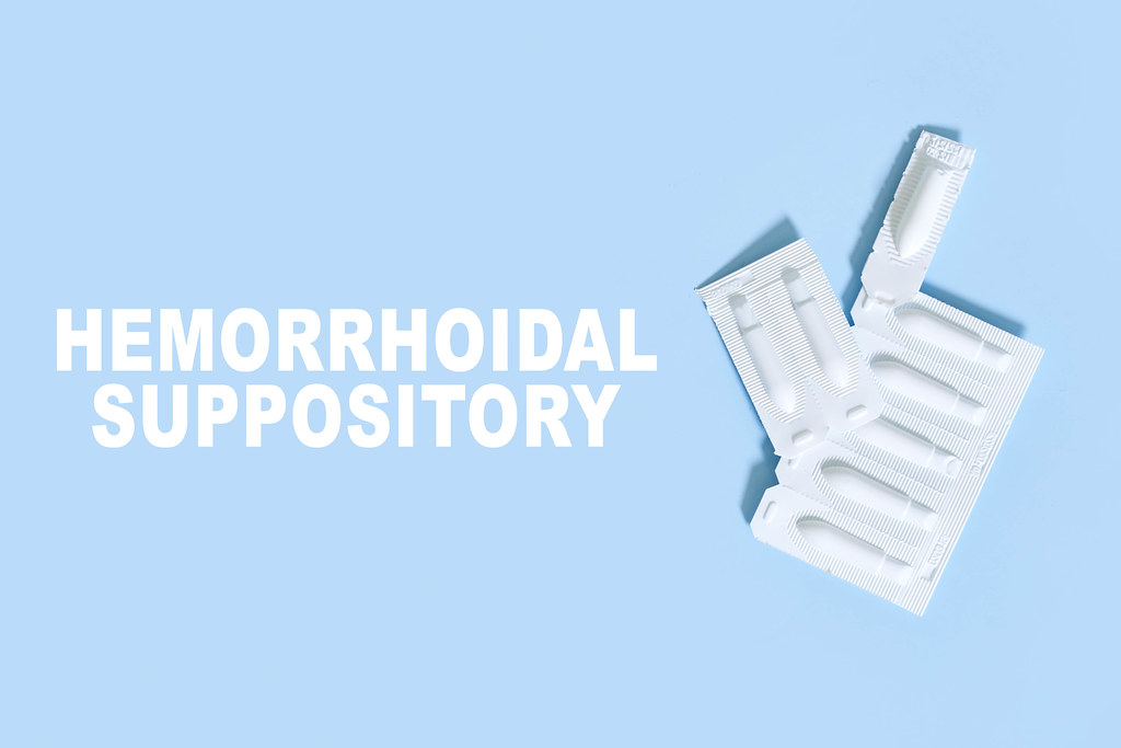 Hemorrhoidal suppositories on bright blue background